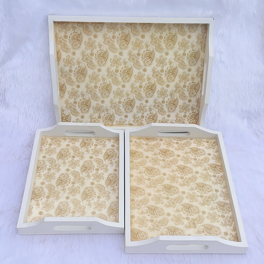 Set of three ivory and gold paisley resin wooden serving trays in small, medium and large sizes