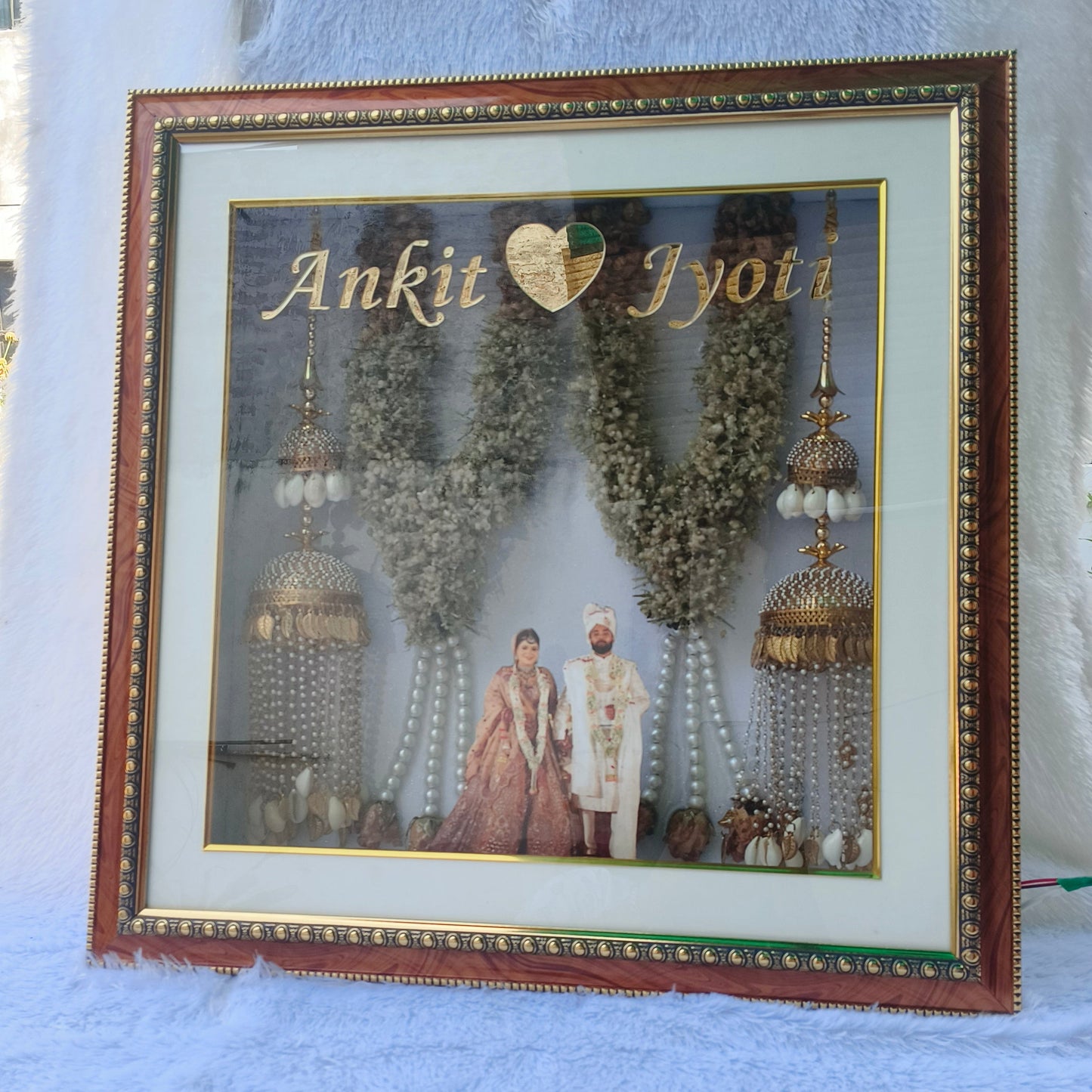 Custom handmade varmala preservation frame with couple photo, names, warm lights and preserved wedding flowers by Shaahi Decor.