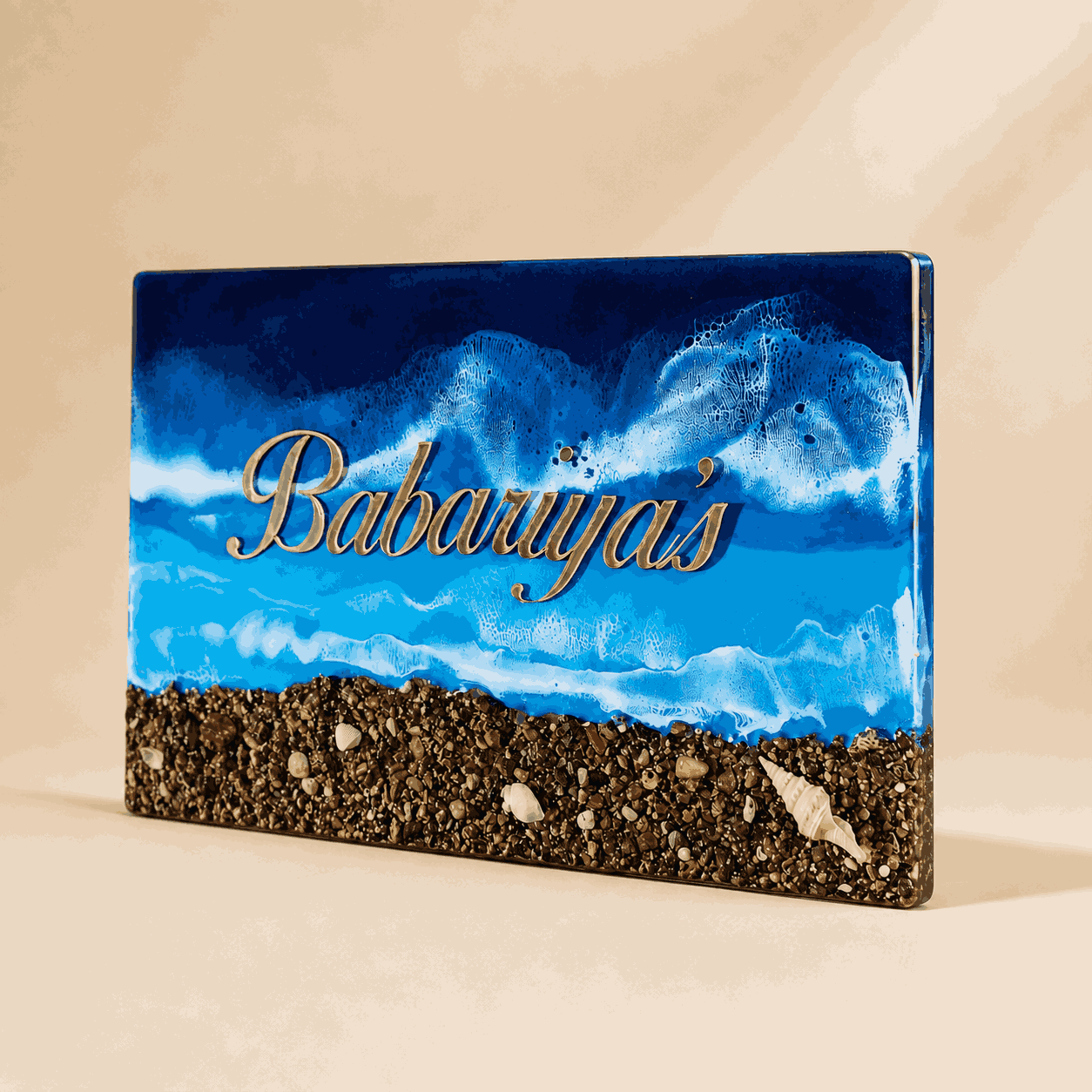 Angle view of Deep Blue Beach Resin Name Plate with glossy ocean resin finish and gold name detail