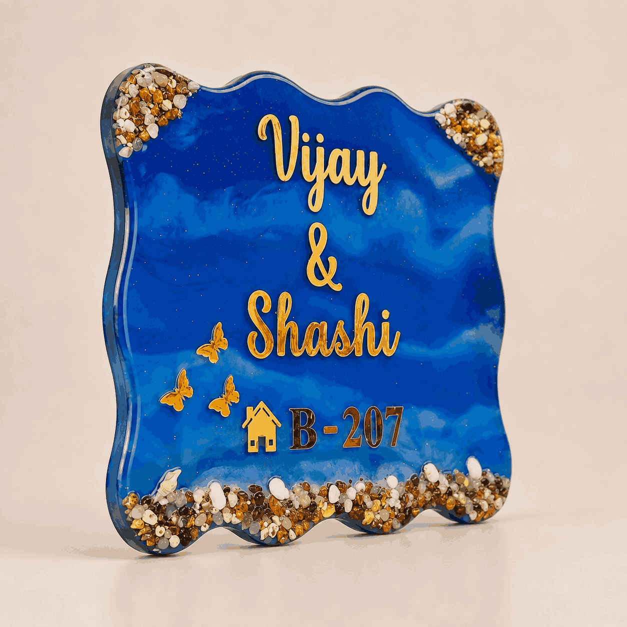 Left angle view of Royal Blue Pebble Resin Name Plate with slim edge, gold lettering and stone details